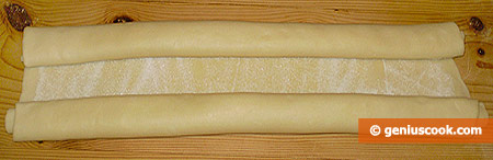 Roll up one side of the dough to the middle, then the other side