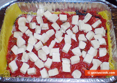 pour over with tomato puree and top with mozzarella cubes
