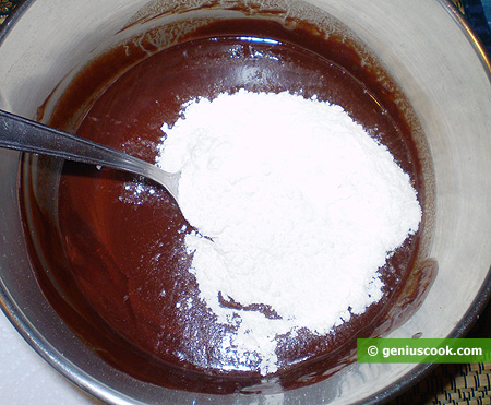 Pour flour into the warm chocolate