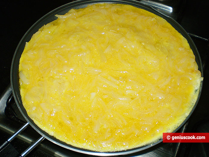 Eggs and onions onto the pan in a thin layer
